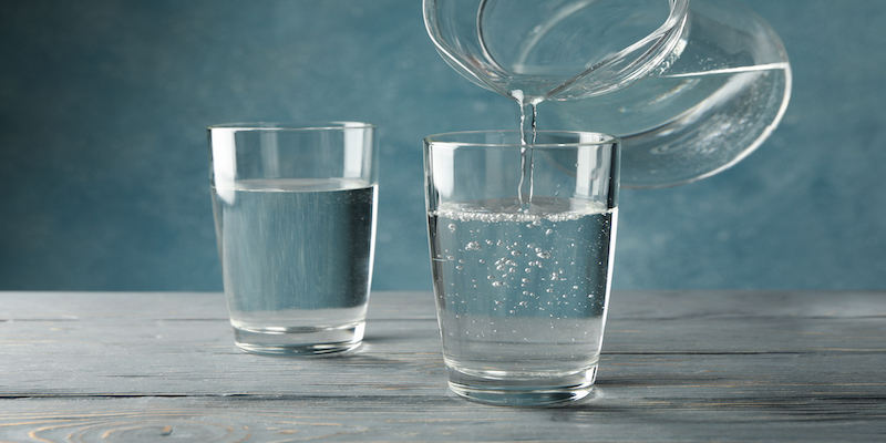 pouring-purified-fresh-water-from-the-jug-in-glass