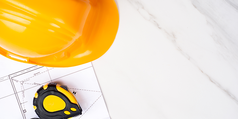 blueprints-measuring-tape-safety-hat-surveyor-dilapidations