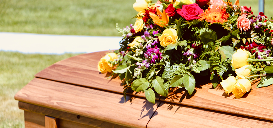 wooden-casket-with-flowers-what-happens-to-shares-when-someone-dies-blog-FEATURED-IMAGE